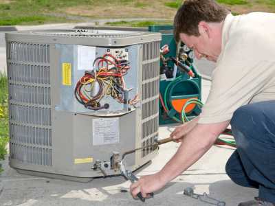 HVAC Tech Working on Heat Pump